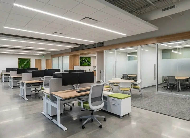 Completed commercial office interior with glass partitions, conference rooms, and modern workspaces.